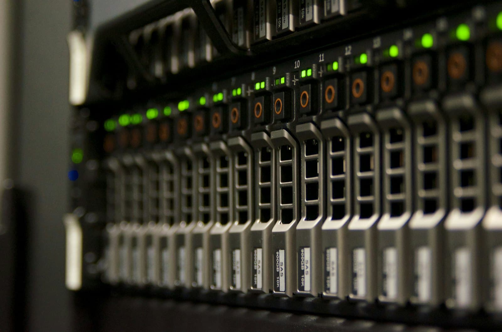 Front of a server rack filled with drive bays, lit by small indicator lights